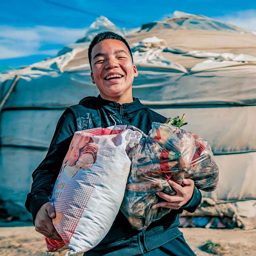 Learn About Children's Hunger Fund: Delivering Hope to Suffering Children Through Gospel-Centered Mercy Ministry Since 1991 About Children's Hunger Fund - Boy Smiling Upon Receiving Bags of Food