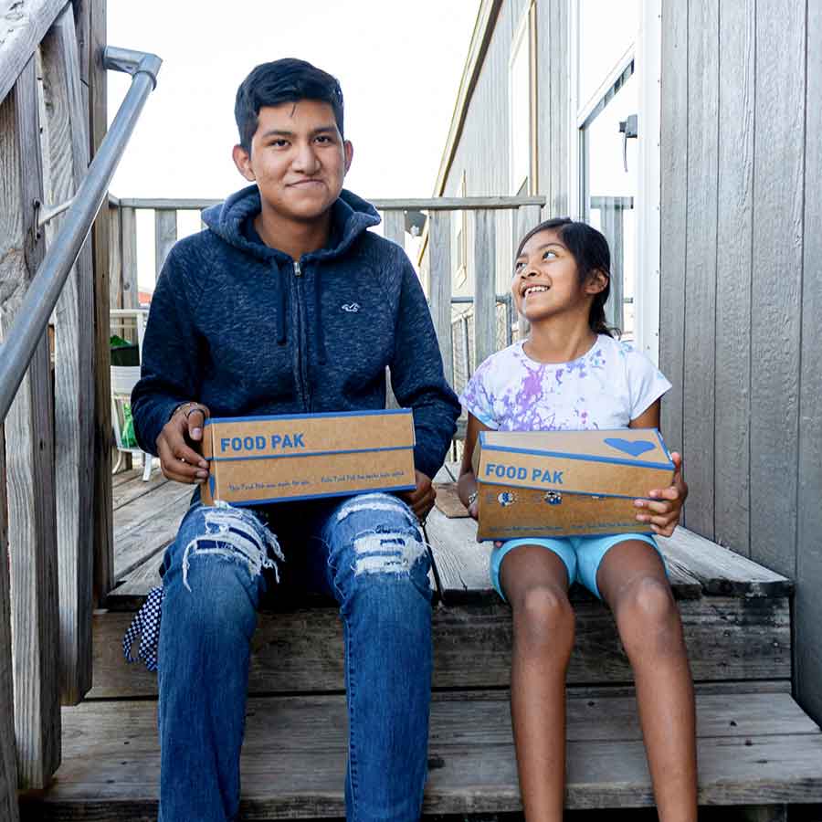 Learn About Children's Hunger Fund: Delivering Hope to Suffering Children Through Gospel-Centered Mercy Ministry Since 1991 About Children's Hunger Fund - Brother and Sister Smiling Upon Receiving Food Paks