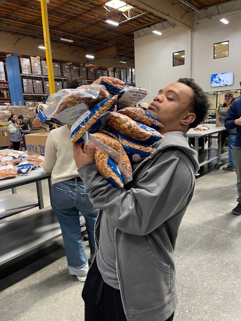 Volunteer carrying bags of food