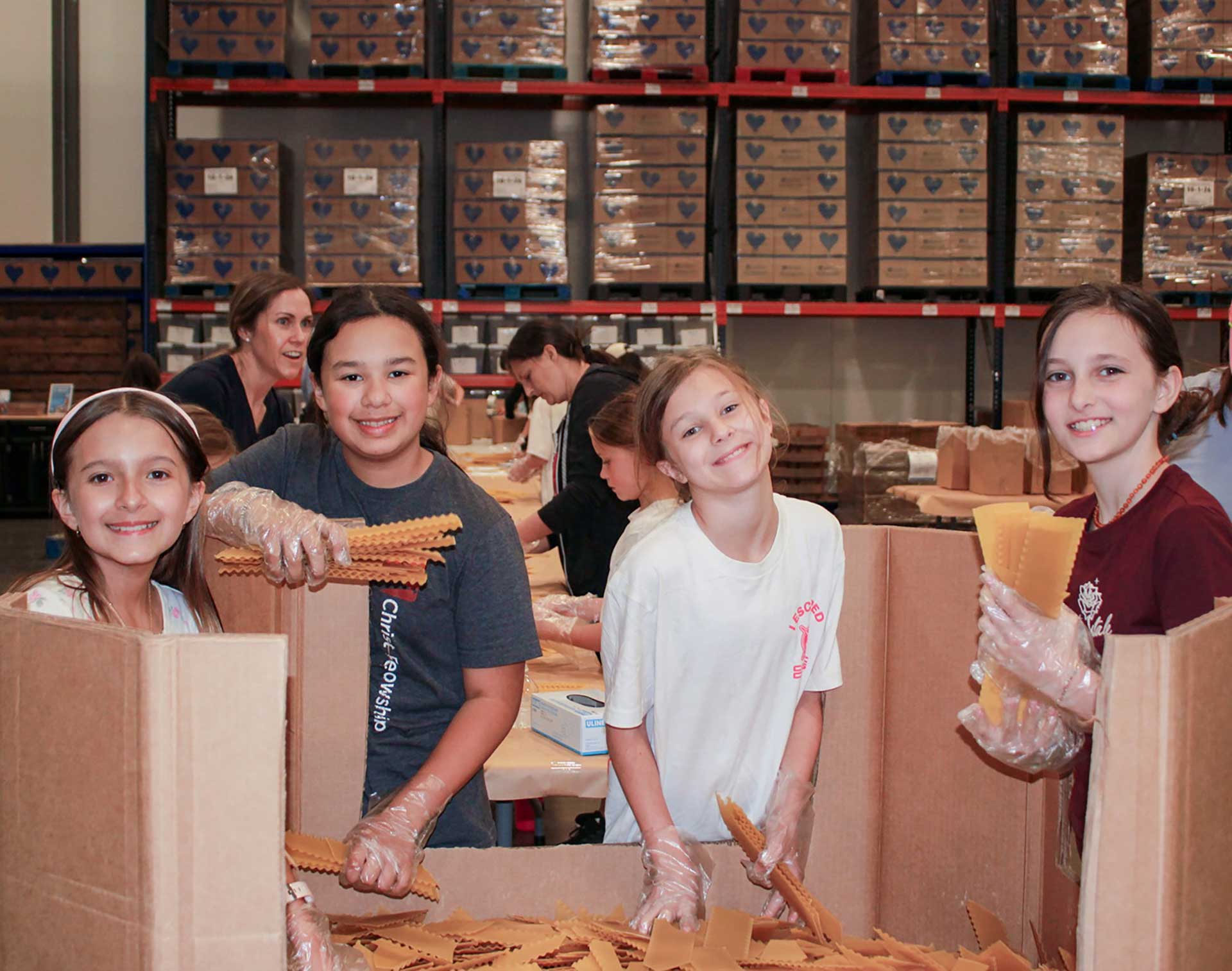 Kids packaging pasta for Children's Hunger Fund