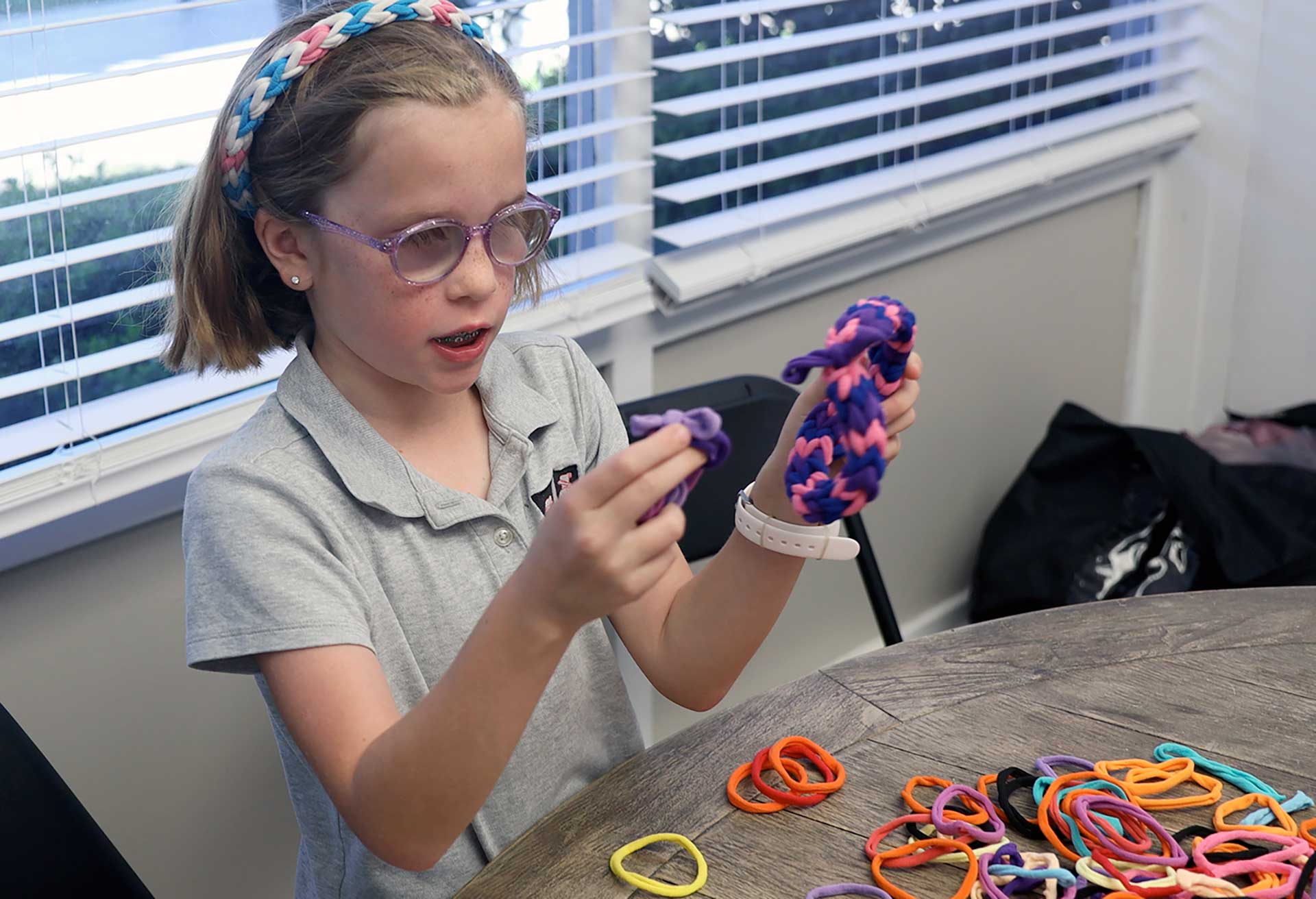 Elsie already knew how to make headbands—crafted from colorful elastic bands that she could weave with her fingers in minutes. She sold them at school and church for a few dollars apiece—a small way she could make an impact. 