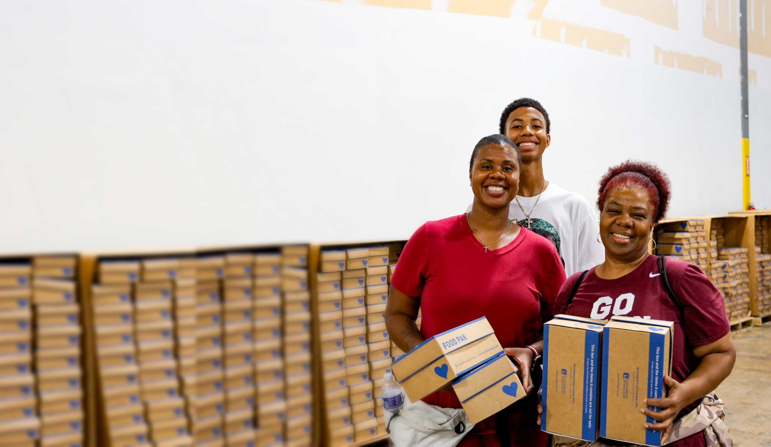 Volunteers and leaders packing Food Paks together